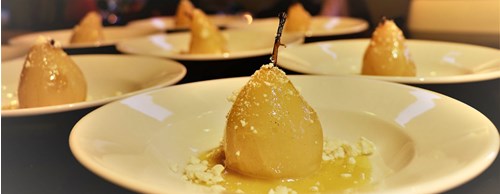 Poached pears on white plates